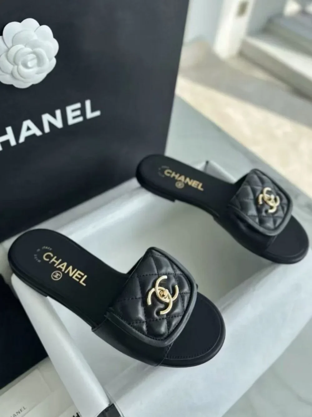 CHANEL Black Quilted Leather CC Turn‑Lock Flat Slide Sandals